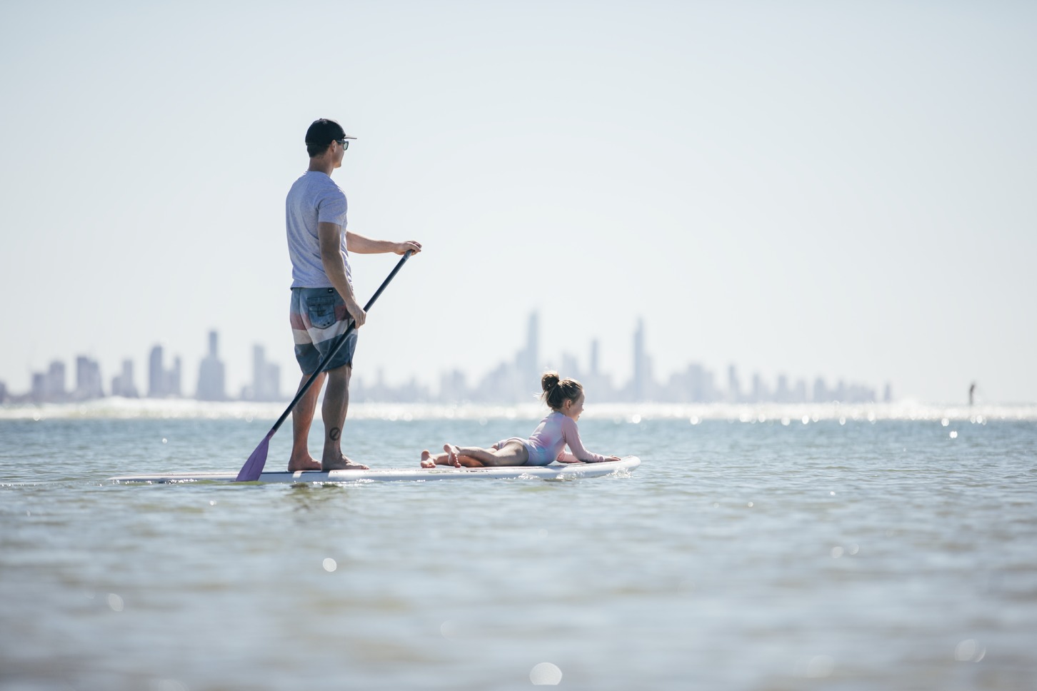 Father-and-daughter-stand-up-paddle-boarding