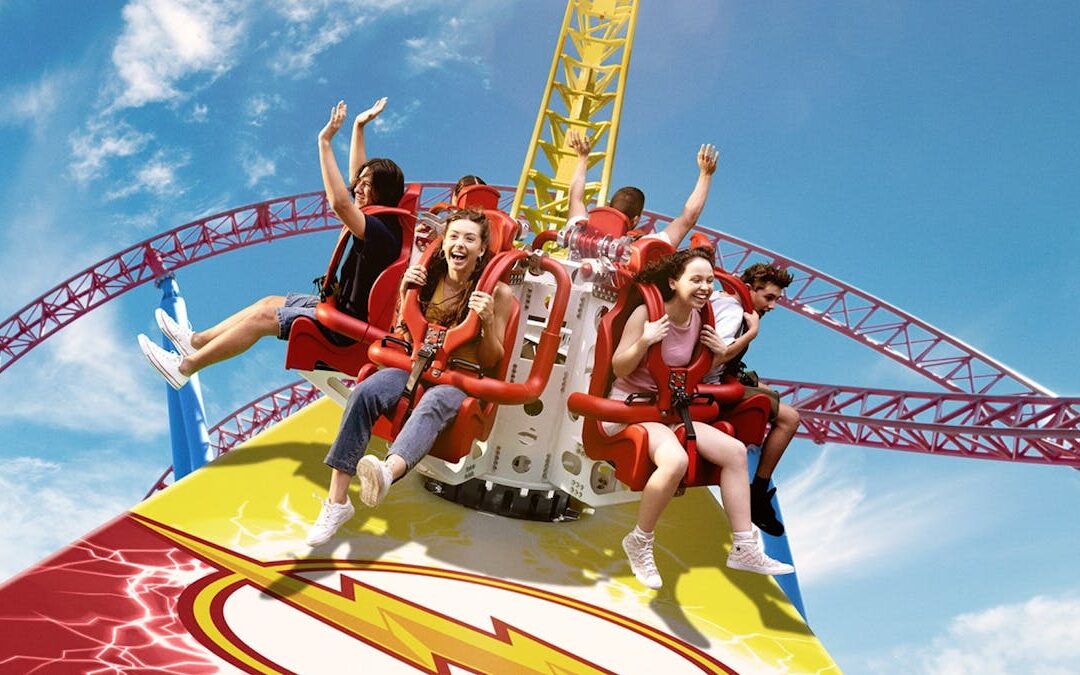 thrill-seekers enjoying a high-speed roller coaster at warner bros movie world, one of the top gold coast attractions